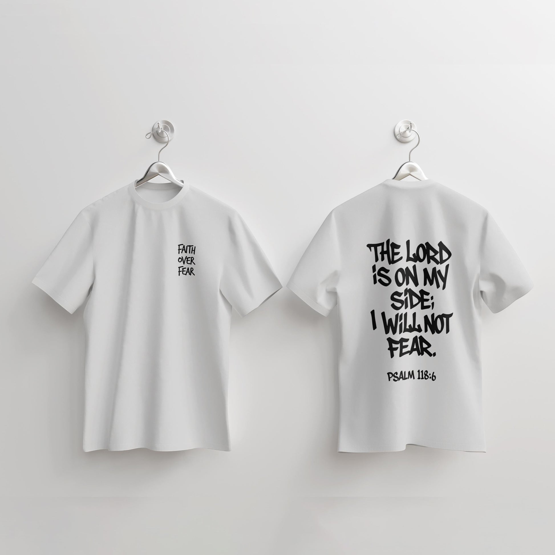 Revel white cotton t-shirt with black text. Front has "FAITH OVER FEAR" on left chest. Back has "THE LORD IS ON MY SIDE; I WILL NOT FEAR. PSALM 118:6".